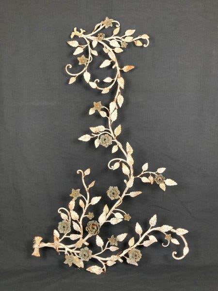 Flower and Leaf Motif Painted Wrought Iron Decoration: Decorative wrought iron sculpture featuring twisting vines with floral and leaf motifs, painted to accentuate its ornamental design. Measures approximately 55 1/4" H x 32" W x 3 1/2" D. Some rust visi