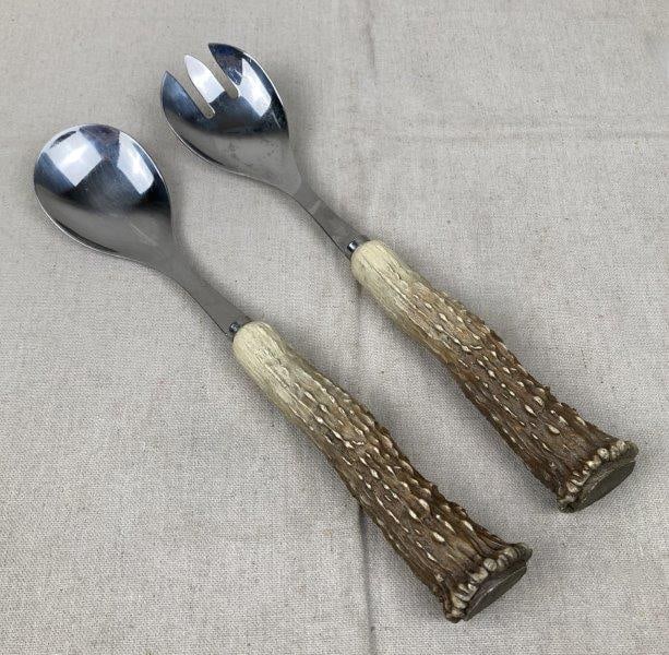 Stag Horn Salad Utensil Set: Handsome stainless-steel salad utensils with stag horn handles, each piece showcasing natural variation and an aged patina. Classic rustic design ideal for table presentation. The spoon measures appro