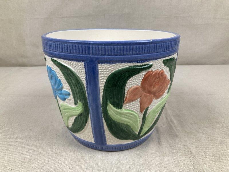 Fioriware Jardinware Pot: Ohio Art pottery jardiniere pot in the majolica style, decorated with vibrant floral motifs. Measures approximately 6 1/2" H x 8 1/2" in diameter. Good condition with one tiny chip to the rim edge.