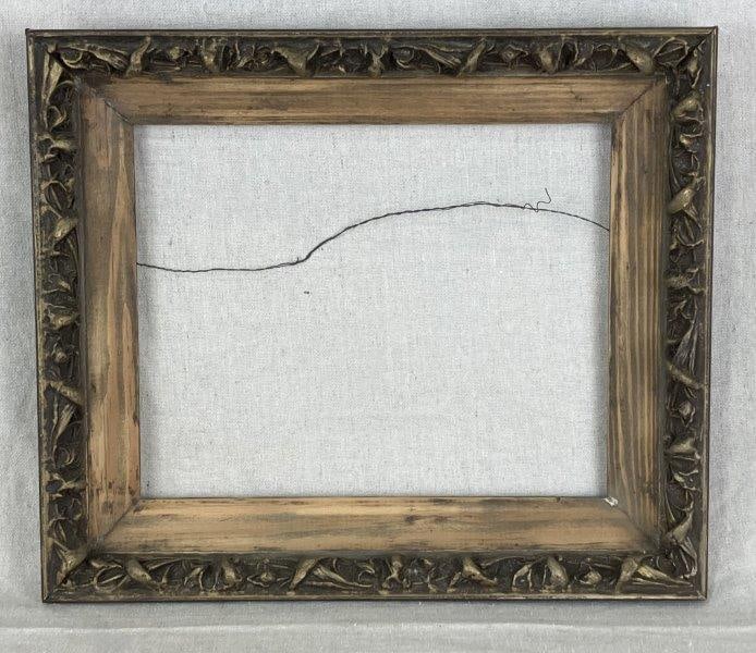 Carved and Gilded Wood Frame: Ornately carved frame with vegetal-inspired details and gold gilding, complemented by a natural pine liner. Measures approximately 11 1/8" H x 13 1/8" W x 2" D. Good condition with wood patina and age