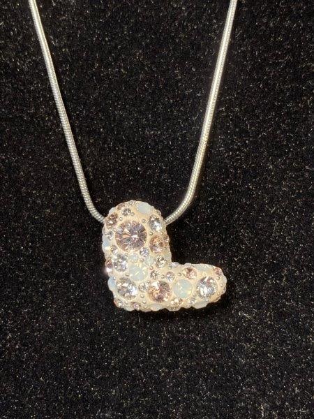 Swarovski Crystal and Enamel Heart Pendant Necklace: A Swarovski crystal and enamel heart pendant necklace, offered with its original named box. The silver-tone heart is beautifully enameled and accented with milky, clear, and pink crystals, creating a 