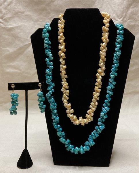 Opalescent Shell Necklaces and Earrings: A grouping of shell jewelry in teal and cream tones with light-reflective, opalescent surfaces. Includes two necklaces, one paired with matching shell dangle earrings. One necklace measures approximat