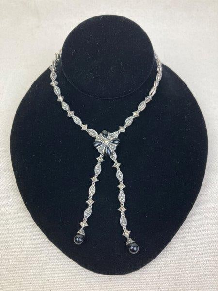 Art Deco-Style Sterling Silver Onyx and Marcasite Lariat Necklace: Sterling silver lariat-style necklace featuring onyx and marcasite accents, with a removable brooch clasp and onyx drop beads at the ends. Total length approximately 32". In good condition with light