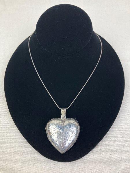 Sterling Silver Necklace with Heart-Shaped Locket: Sterling silver fold-out heart locket with paisley-etched design, marked 925 and Italy stamped. Suspended from a sterling chain measuring approximately 20" long; the locket measures approximately 1 3/