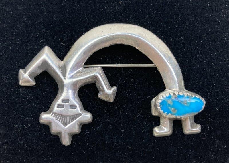 Native American Sterling Silver and Turquoise Rainbow Man Pendant-Brooch: Navajo Yei Naja pendant-brooch crafted in sterling silver, featuring a turquoise stone at the feet. Unmarked. Measures approximately 1 3/8" H by 2 1/8" W. In good condition with light wear consistent 