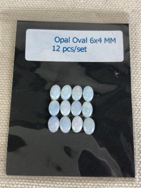 Set of 12 Opal Oval Gemstones: Collection of twelve oval-cut opals displaying fiery white play-of-color. Each gemstone measures approximately 6 x 4 mm. In good condition.