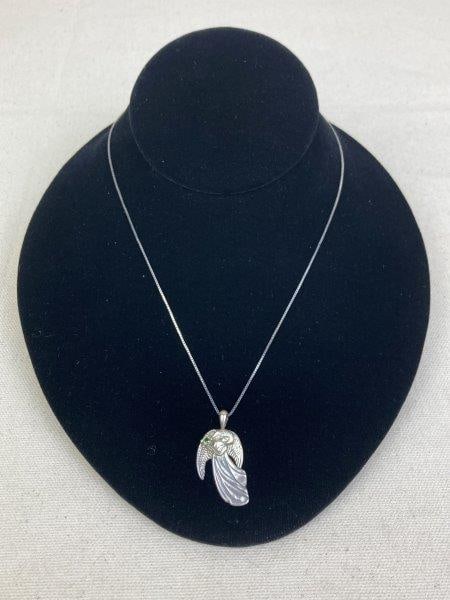 Sterling Silver Guardian Angel Necklace with Peridot: Sterling silver box chain suspending a finely crafted angel pendant accented with a vivid green peridot gemstone, symbolizing protection and harmony. Marked 925. Measures approximately 19" long. In go