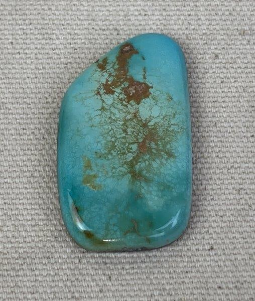 Royston Turquoise Cabochon: Large Royston turquoise gemstone displaying striking color variations from soft greens to rich sky blues, highlighted by a distinctive brown matrix. Measures approximately 1 5/8 inches in height and 1