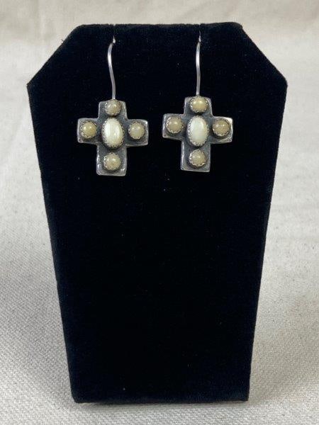 Sterling Silver Native American Earrings by Daslin: Sterling silver Native American earrings crafted in the shape of a cross and accented with decorative stone inlays. Stamped DASLIN on the reverse. Each measure approximately 1 3/8" long. In good condi