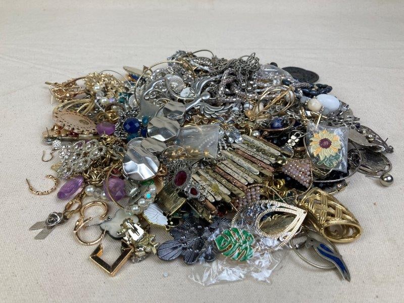 Lot of Costume Jewelry in Mixed Metal Tones: Assorted collection of costume jewelry including necklaces, earrings, pins, and more, in silver, gold, and copper tones. Pieces vary in size, design, and condition, with most showing light wear consis