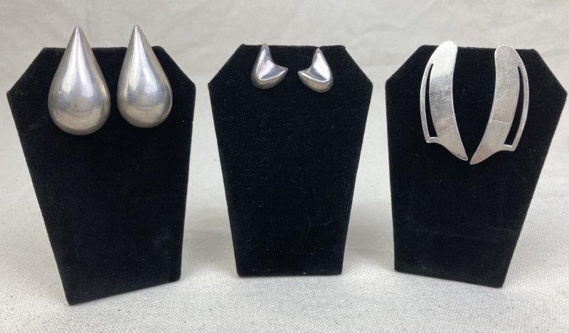 Three Pairs of Sterling Silver Modernist Earrings: Collection includes three pairs of sterling silver earrings in modernist designs: one pair of teardrop earrings measuring approximately 1 1/2" long; one pair of abstract curved elongated earrings meas
