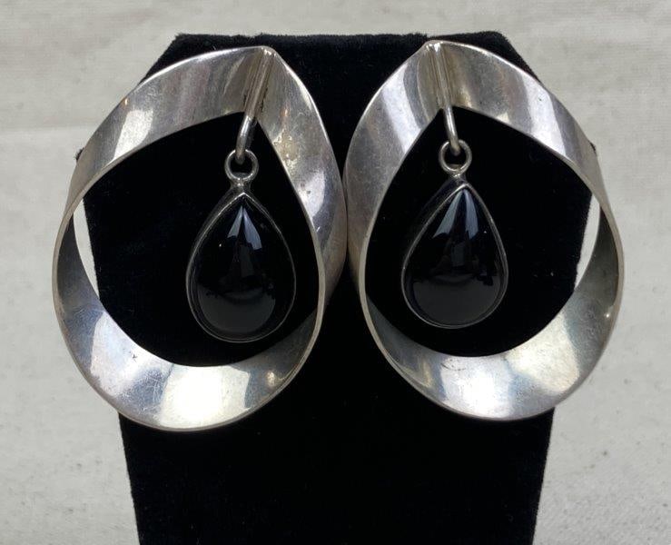 Vintage Sterling Silver and Onyx Modernist Earrings, Signed RJA: Elegant vintage modernist earrings featuring teardrop-shaped onyx stones suspended within sculptural sterling silver frames. Signed RJA on the reverse. Each earring measures approximately 2" x 1 1/4".