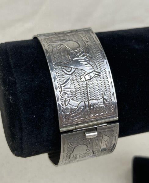 Sterling Silver Story Panel Bracelet: Charming sterling silver story panel bracelet depicting a detailed scene of a farmer and a lazy donkey. Signed on the reverse of the clasp. Measures approximately 6 5/8" long and weighs 41.4 grams. In