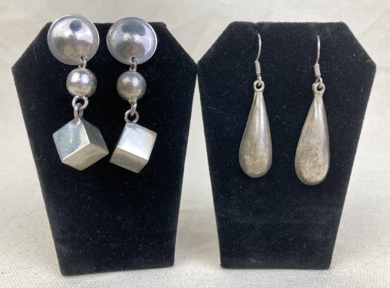 Two Pairs of Modernist Mexican Sterling Silver Earrings: Collection of two pairs of modernist Mexican sterling silver earrings, including one Taxco pair in an elegant teardrop form, stamped 925 Mexico TD-54 and measuring approximately 2" long; together with