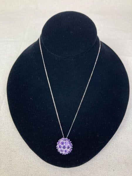 Sterling Silver Necklace with Amethyst Pendant: Elegant sterling silver necklace featuring a round amethyst pendant measuring approximately 3/4" in diameter, suspended from a sterling silver chain stamped 925 on the clasp and measuring 17" long. In