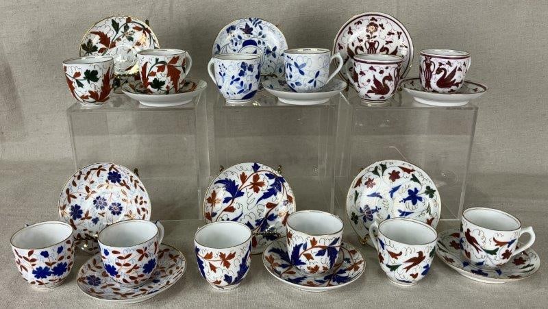 Royal Vienna Porcelain Demitasse Cups and Saucers: Elegant set of Royal Vienna porcelain demitasse cups and saucers, each finely crafted and hand-painted with a variety of motifs in richly detailed patterns. The set is housed in a fitted presentation 