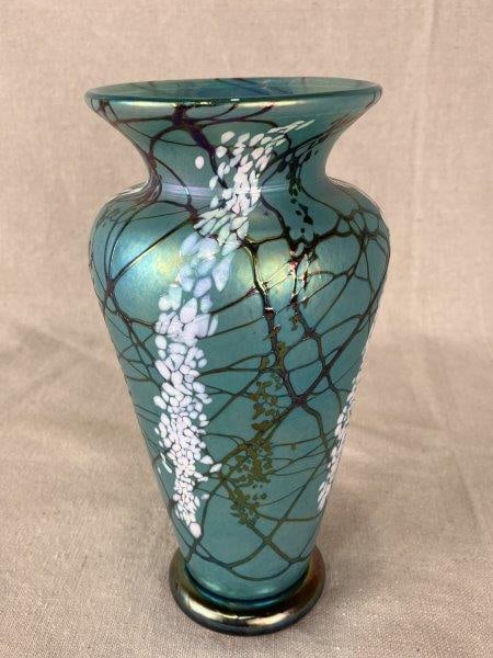 Vines Art Glass Vase: Elegant art glass vase featuring rich iridescent layered tones with a dominant light turquoise hue. The graceful curving form highlights its handcrafted artistry and decorative appeal. Measures approx