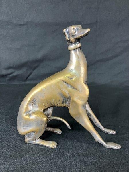 Silver-Washed Brass Greyhound Sculpture: The elegant and graceful form conveys a sense of motion, with finely realized facial features adding lifelike detail. Measures approximately 9 3/4" H x 8 7/8" W x 3" D and is in good condition with so