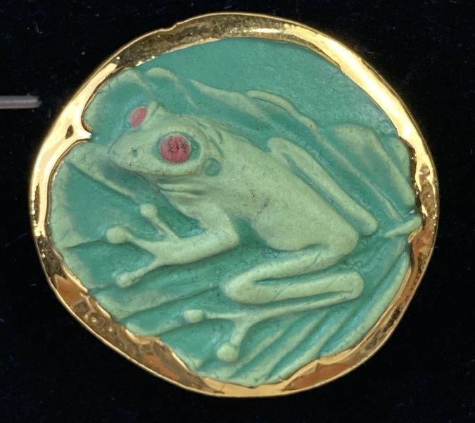 Brook Andrews Tree Frog Brooch: Whimsical brooch by Brook Andrews, featuring a playful tree frog design. Signed on the reverse. Measures approximately 1 1/4'' in diameter. Good condition.