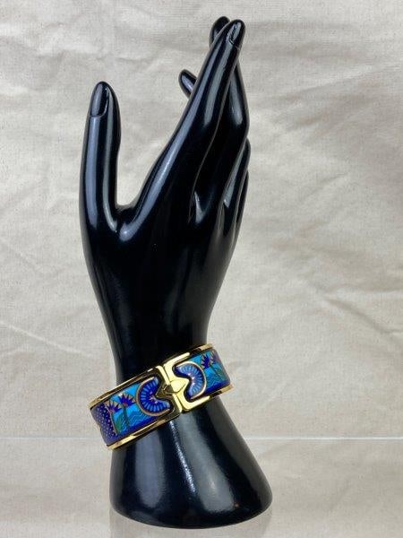 Michaela Frey Wien Enamel Bangle: Stunning gold-plated enamel bangle by Michaela Frey Wien, beautifully decorated in rich dark blues accented with gold detailing. A fine example of the brand's signature artistry. Bangle measures appro