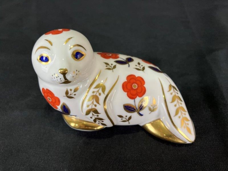 Royal Crown Derby Porcelain Seal: Charming porcelain seal by Royal Crown Derby, decorated in traditional Imari tones with a delicate, stylized form from this distinguished English maker. Measures approximately 3" H x 5 1/4" W x 3 1/4"
