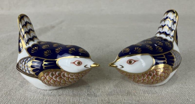 Pair of Royal Crown Derby Wrens: Delightful pair of Royal Crown Derby bone china wrens, finely hand-painted with delicate detail and crafted in smooth, elegant forms, exemplifying the English porcelain tradition. Measures approximate