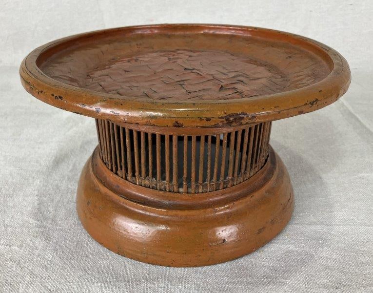 Chinese Lacquered Wood Ceremonial Dish: Traditional ceremonial dish crafted in lacquered wood, finished in rich sienna tones and executed in a classic form. Measures approximately 5" H x 9 1/8" in diameter and shows some cracking to the lac