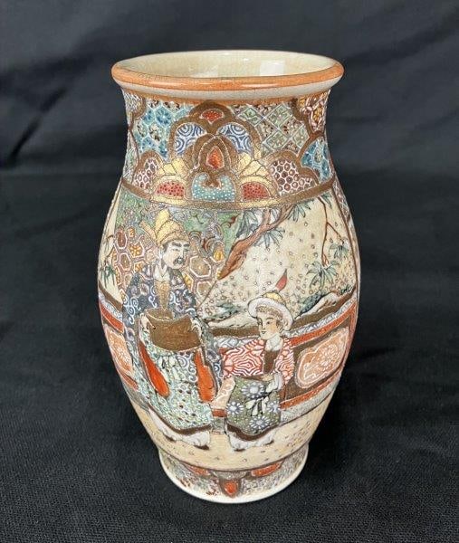 Japanese Satsuma Vase with Figural Motif: Charming Satsuma porcelain vase featuring a figural motif of a man and child in traditional dress, richly decorated with ornate gilded details characteristic of the style. Measures approximately 6 3/8