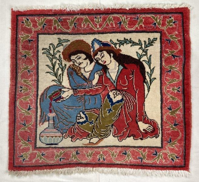 Hand Knotted Pictorial Rug: Charming hand-knotted rug depicting two lovers at the center, framed by a floral border. Executed in deep reds with ivory accents. Measures approximately 29'' x 32''. Good condition with light wear co