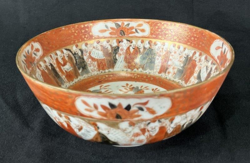 Japanese Kutani Painted Porcelain Bowl: Vibrant Kutani porcelain bowl decorated with a multitude of figures in a traditional style, executed in rich gold, red, and orange tones. A fine example of historical Kutani artistry. Measures approxi