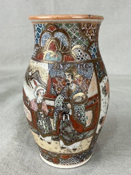 Japanese Satsuma Porcelain Vase: Hand-painted Satsuma porcelain vase with gilded embellishments, decorated in characteristic style with male and female figures depicted on opposite sides. Measures approximately 6 1/4" H x 3" in diame