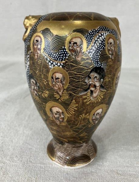 Satsuma Painted Porcelain Vase: Traditional Japanese Satsuma porcelain vase decorated with a multitude of figures, richly accented with gold embellishments and detailed brushwork. Measures approximately 6" H x 3 1/4" in diameter. Go