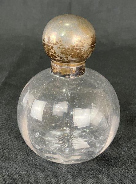 Perfume Bottle with Sterling Silver Top: Elegant perfume bottle with a beautifully rounded glass form, topped with a sterling silver cap stamped with the English lion passant, denoting silver content and origin.Measures approximately 5" H x 