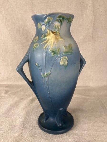 Roseville American Art Pottery Vase: Classic American art pottery vase by Roseville, featuring a three-dimensional "Columbine" motif against a graceful blue ground, completed with two angular handles. A fine example of Roseville’s 