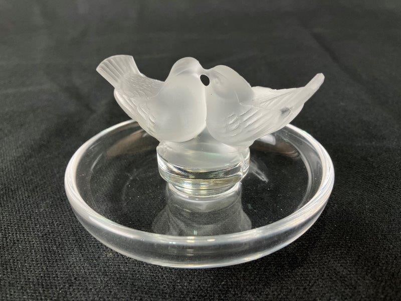 Lalique Art Glass Paperweight with Birds: Charming Lalique art glass paperweight depicting two birds in the maker’s characteristic refined style. Inscribed signature to base. Measures approximately 2" H x 3 5/8" in diameter. Good overal