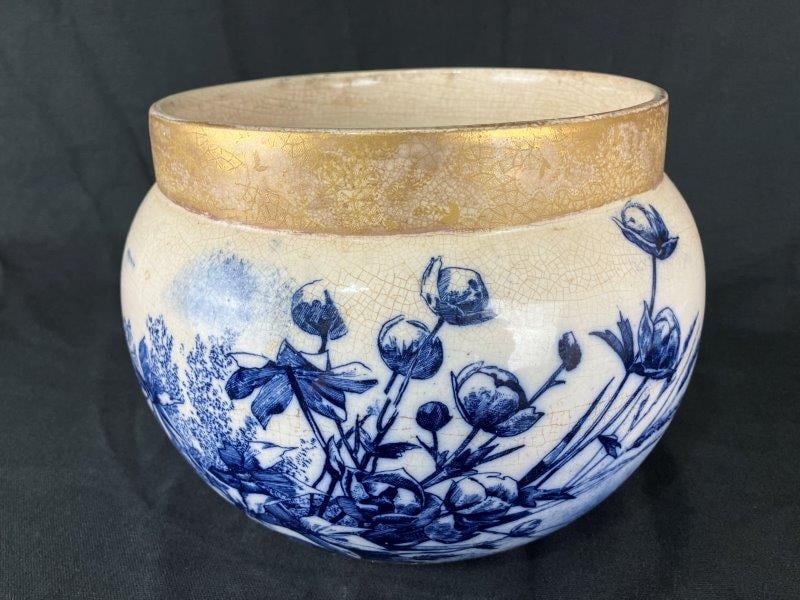 Flow Blue Jardiniere: Refined jardiniere decorated with rich cobalt floral designs, highlighted with gilded decoration along the upper lip. A fine decorative example of classic English transferware. Measures approximately
