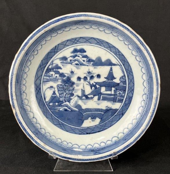 Chinese Canton Dish: Blue and white Chinese Canton dish decorated with a lush landscape featuring pagodas and trees, accented by ships upon the water in a traditional scenic design. Measures approximately 1 3/8" H x 8 1/8