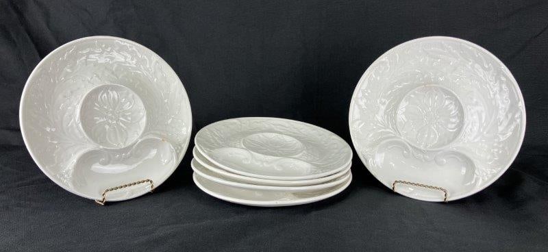 Six Faïencerie de Gien Porcelain Plates: Elegant porcelain plates crafted by Faïencerie de Gien, France, each featuring ornate embossed floral designs with a central flower surrounded by decorative scrollwork. Each measures approximatel