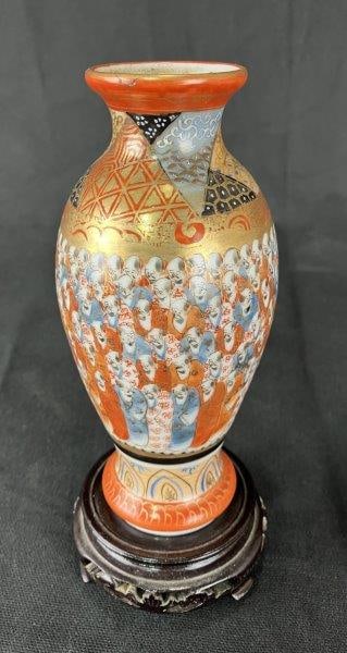 Japanese Kutani Porcelain Vase: Small Kutani porcelain vase richly decorated with a multitude of figures, enhanced by intricate decorative designs that accentuate the central figurative motif. A fine example of Japanese craftsmanshi