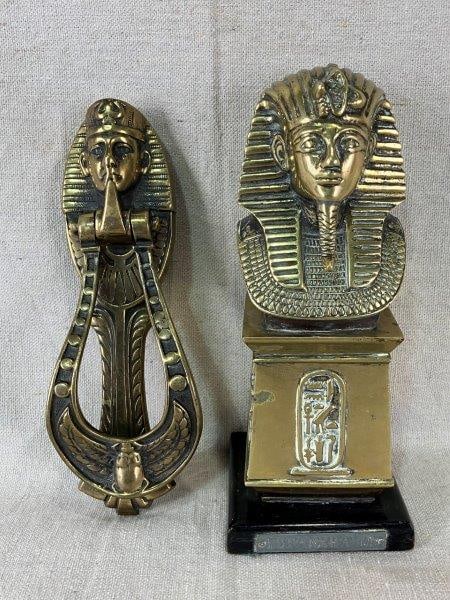 Tutankhamun Brass Bust and Door Knocker: Pair of decorative brass pieces inspired by the discovery of Tutankhamun's tomb and the early 20th-century revival of Egyptology. Both depict the Egyptian pharaoh in finely cast detail with warm brass