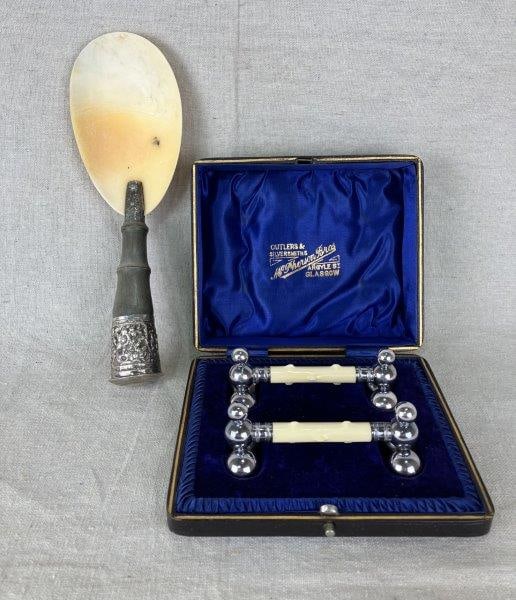 Silverplate Berry Spoon and Knife Rests: Elegant silverplate grouping including a berry spoon and knife rests, the latter made by McPherson Brothers of Argyle Street, Glasgow. The berry scoop features intricate metalwork with embossed surfac