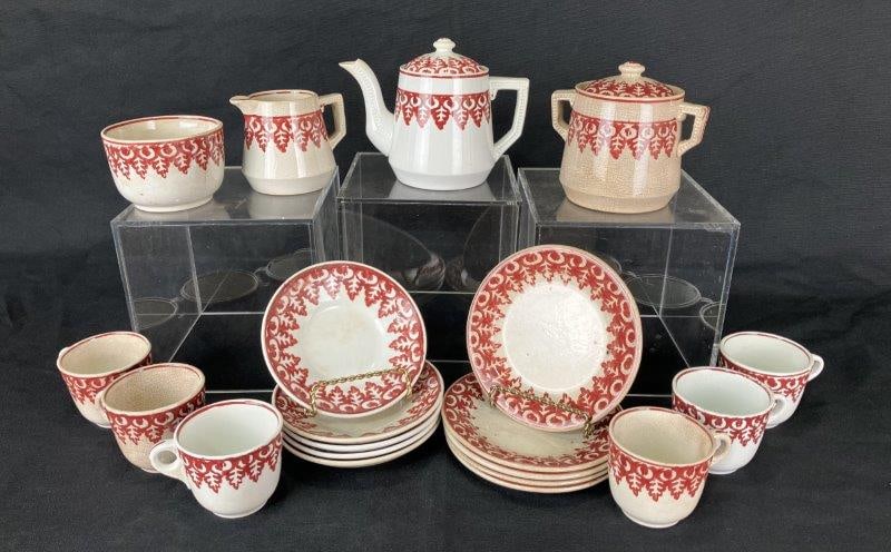 Child's Staffordshire Tea Set: Charming child's tea set including cups and saucers, tea pot, waste, creamer, and sugar, decorated in the traditional technique. The teapot measures approximately 5" H x 6 1/4" W x 3 1/8" D. Some mino
