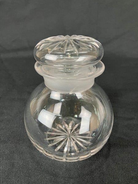 Glass Covered Jar: Elegant covered glass jar featuring luminous, ornate patterning with a prismatic design, topped with a matching lid. Measures approximately 5 1/2" H x 3 7/8" in diameter, with the body in good conditi