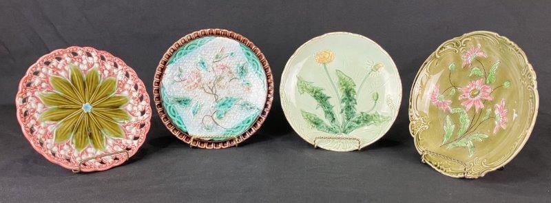 Four Majolica Floral Motif Plates: Group of majolica plates, some German-made, each decorated with a variety of floral motifs in the classic 19th-century majolica style. Each plate measures approximately 7/8" H x 7 3/4" in diameter. So