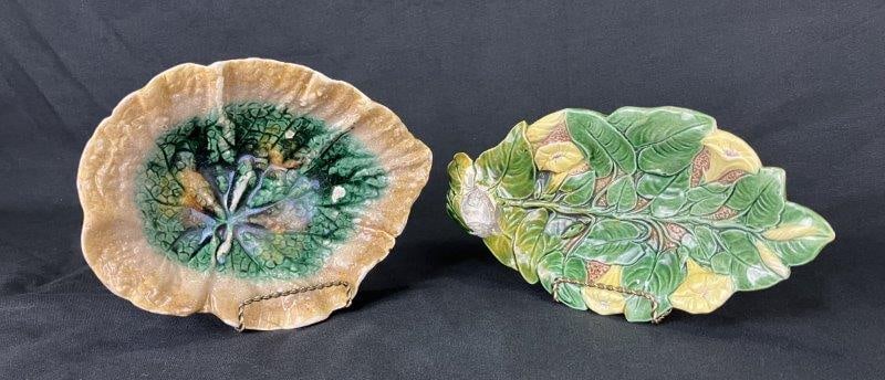 Pair of Majolica Leaf Plates Featuring One Estruscan: Vibrant pair of majolica plates, each decorated with rich glazing in tones of brown and green on traditional majolica surfaces. One plate features a floral motif and measures approximately 1 5/8" H x 