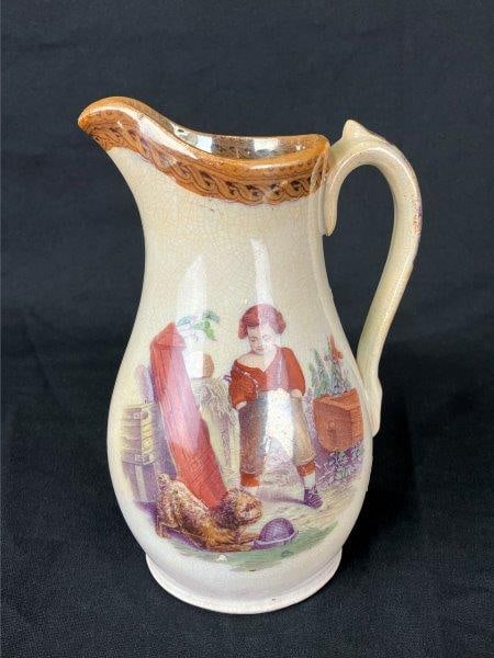Lockhart & Co. Pollokshaws “Charlie” Pitcher: Scottish glazed pitcher by Lockhart & Co., featuring an iridescent luster finish and a charming scene of young Charlie at play with his dog. The piece is formed with an elegant curving profile, highli