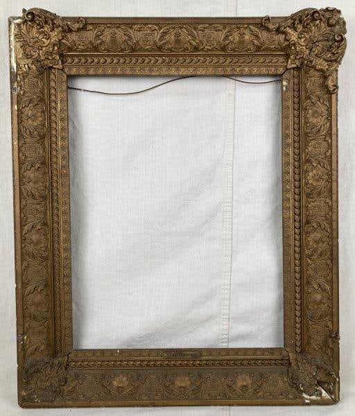 19th Century Gilt Frame: Elegant 19th-century gilt frame featuring richly ornate molded decoration, a fine example of period craftsmanship and design. Outer frame measures approximately 23 3/4" x 28 1/2", with an inner openin