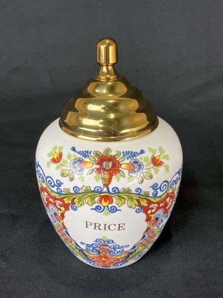 Royal Goedewaagen Delft Tobacco Jar: Decorative Delft tobacco jar by Royal Goedewaagen, featuring a robust curving porcelain form decorated with vibrant floral motifs and completed with a brass lid. Measures approximately 7" H x 4" in di