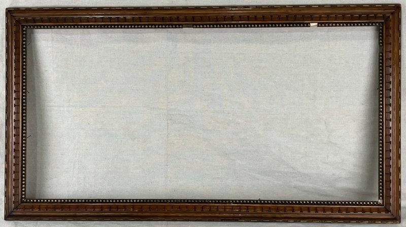 Carved Wood Frame: Ornate carved wood frame with antique appeal, featuring detailed decoration and a beaded liner. Measures approximately 33 3/4" H x 18" W x 1" D. Some loss and wear consistent with age.