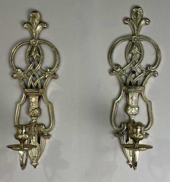 Brass Wall Sconces: Pair of brass wall sconces with rich floral patterning and delicate scrollwork in an Art Nouveauâ€“inspired style. Each measures approximately 16" H x 5 1/8" W x 5" D. Overall good co